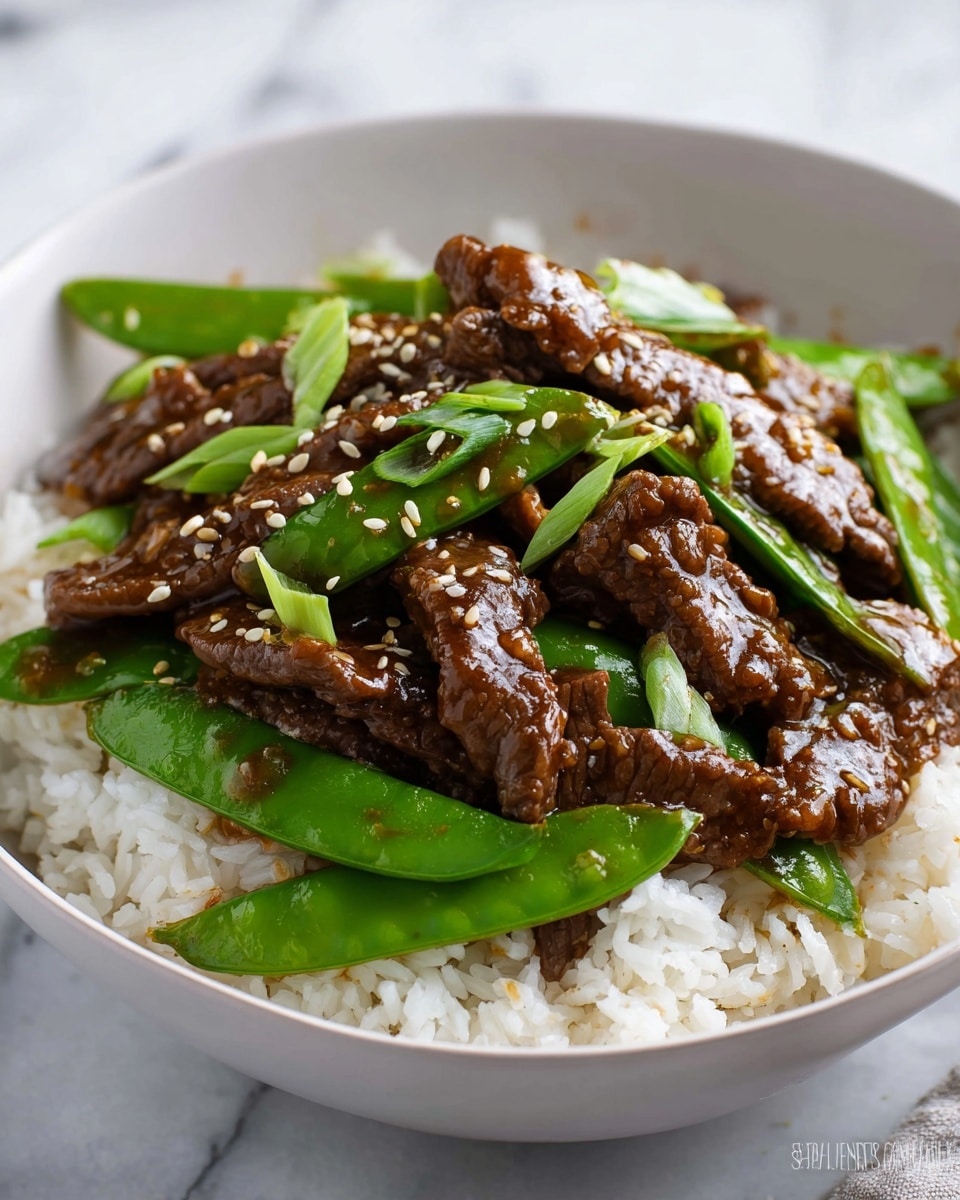 A white bowl holds a bed of soft, fluffy white rice as the base layer. On top, there are bright green snow peas with a shiny, smooth texture, spread evenly across the rice. The main layer above the peas is made up of tender, dark brown strips of beef coated in a glossy sauce. Thin slices of fresh green onions are scattered over the beef, adding a fresh pop of color, and toasted sesame seeds are sprinkled lightly for texture. The dish is placed on a white marbled surface. photo taken with an iphone --ar 4:5 --v 7
