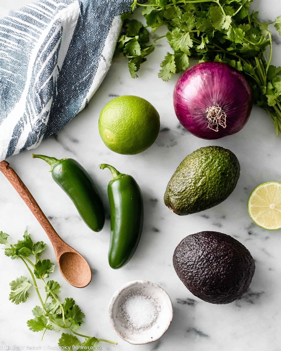 The image shows fresh ingredients laid out on a white marbled surface, including three green jalapeno peppers with stems and leaves, a whole green lime, a ripe green avocado, a dark purple avocado, a small bunch of bright green cilantro leaves, a whole red onion, and a small white bowl of coarse salt with a wooden spoon resting inside. A blue and white striped cloth is partially visible at the top left corner. photo taken with an iphone --ar 4:5 --v 7