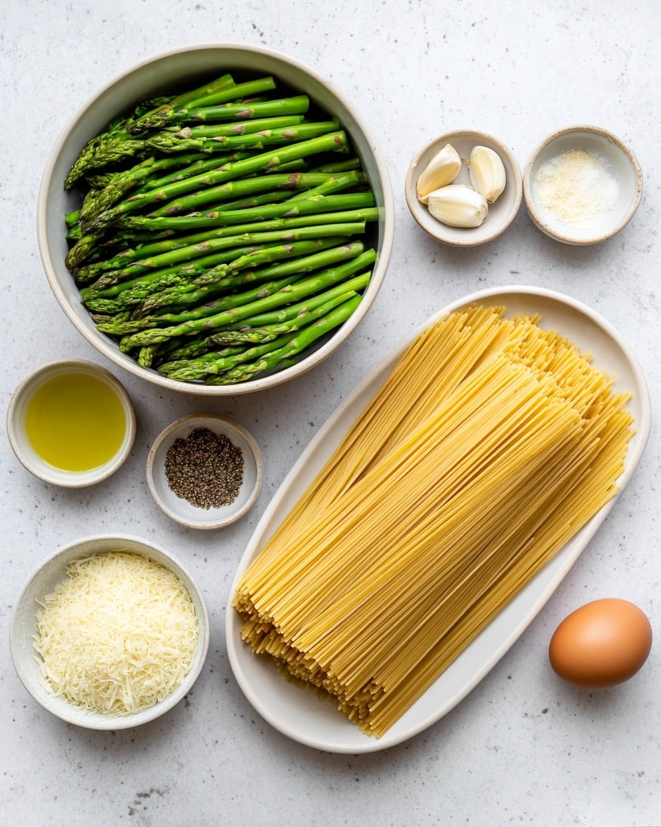 The image shows several cooking ingredients neatly arranged on a white marbled surface. There is a large bowl filled with cut green asparagus pieces on the left side. To the right, a white long oval plate holds uncooked spaghetti strands stacked evenly in a single layer. Surrounding these main items are smaller white bowls holding grated cheese, olive oil, black pepper and salt mix, three garlic cloves, and a single brown egg, all spaced apart. The colors are fresh and natural, with green, yellow, beige, and white tones. Photo taken with an iphone --ar 4:5 --v 7