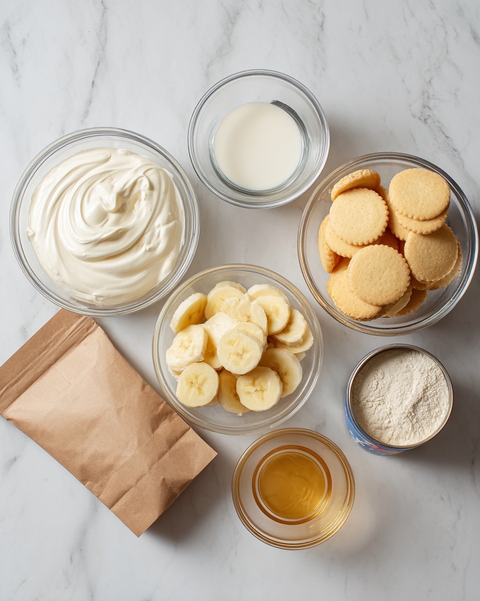 The image shows six clear glass containers and a small brown paper bag on a white marbled surface. The containers hold different ingredients: one has smooth white heavy whipping cream, another has clear water, a third bowl is filled with round golden Nilla wafers, a fourth bowl contains yellow sliced bananas. A small glass holds a light amber liquid of vanilla, an opened can reveals creamy sweetened condensed milk, and a small brown paper bag holds vanilla pudding powder. Each ingredient is labeled with bold black text placed near the containers. The scene is bright with a clean and simple look, photo taken with an iphone --ar 4:5 --v 7