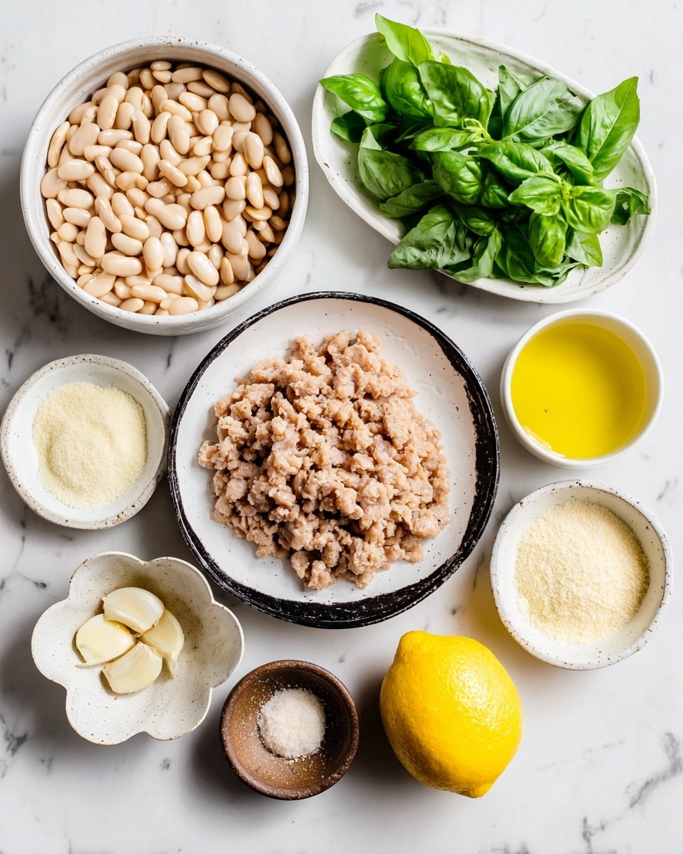 The image shows several bowls and plates with different ingredients on a white marbled surface. In the center, there is a white round plate with black on one side, filled with a layer of chopped light brown textured meat. To the left is a white bowl filled with a layer of whole light beige beans. Above the bowl of beans is a white oval plate holding a bunch of fresh green basil leaves. On the right side of the meat plate, there is a white bowl filled with a yellow liquid layer. Below that is another white bowl filled with a pale yellow powdery cheese layer. Next to this bowl is a small white flower-shaped dish with two light yellow garlic cloves. Next to the garlic cloves is a whole bright yellow lemon placed directly on the surface. Above the lemon and cheese is a small round brown bowl holding two powders side by side – one white and one light beige. Photo taken with an iphone --ar 4:5 --v 7