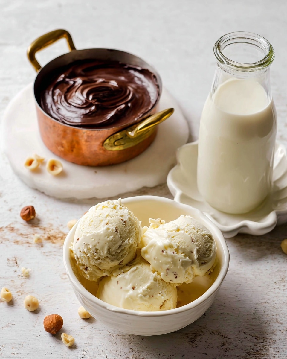 A white bowl holds three scoops of creamy vanilla ice cream with visible small vanilla specks, showing a smooth and slightly textured surface. Behind it is a small copper pot with golden handles filled with thick, glossy dark chocolate spread that has smooth swirls on top. To the right, a clear glass bottle filled with white milk sits on a white flower-shaped plate, the milk looking fresh and creamy. Around them, small broken hazelnuts are scattered on a white marbled surface. photo taken with an iphone --ar 4:5 --v 7
