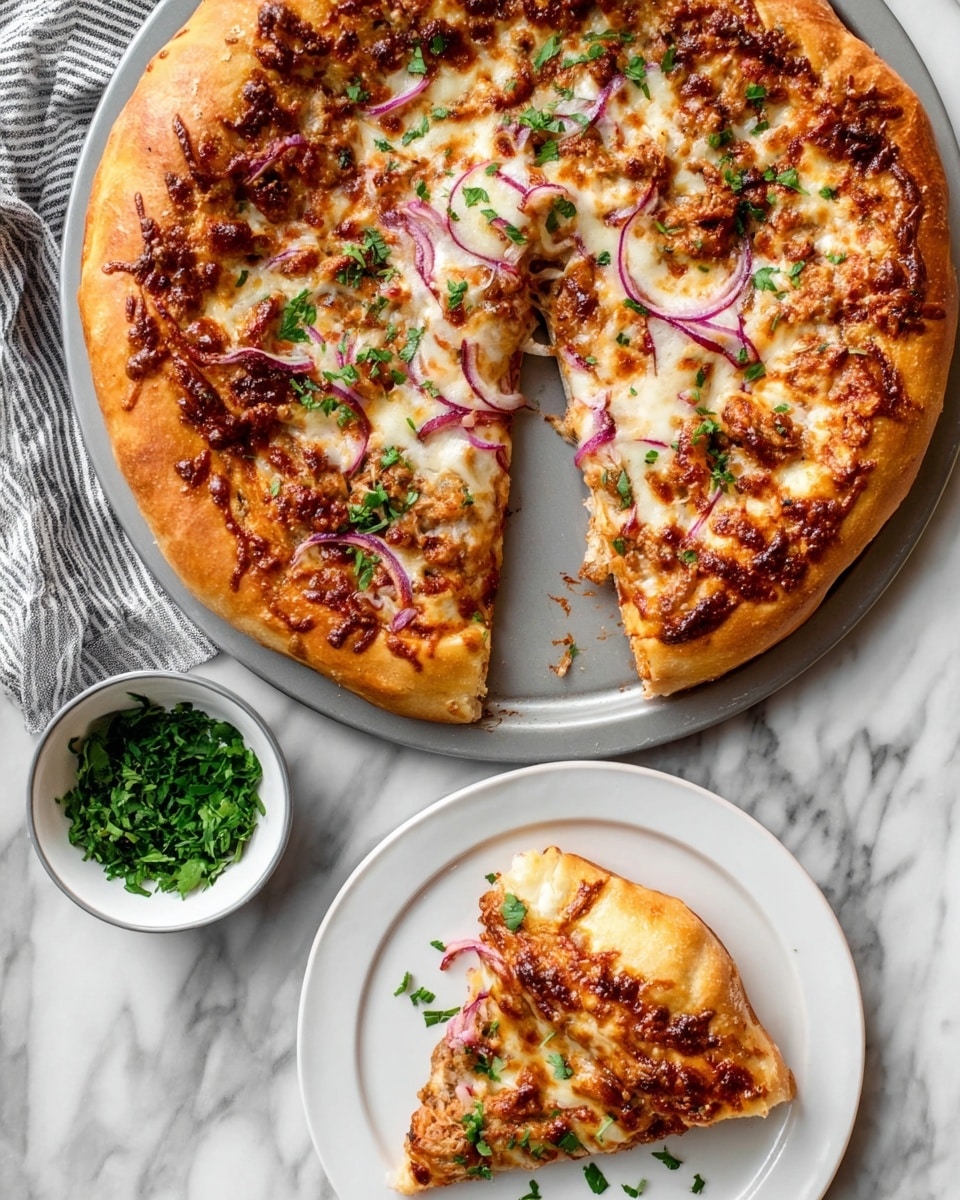 A pizza with a thick golden-brown crust sits on a round pan, one slice taken and placed on a white plate below it. The pizza is topped with a layer of melted light golden cheese, scattered pieces of cooked meat in a reddish sauce, thin purple slices of red onion, and sprinkled with fresh green herbs. The surface under the pan and plate is white marble. Next to the plate is a small bowl filled with fresh green herbs. photo taken with an iphone --ar 4:5 --v 7