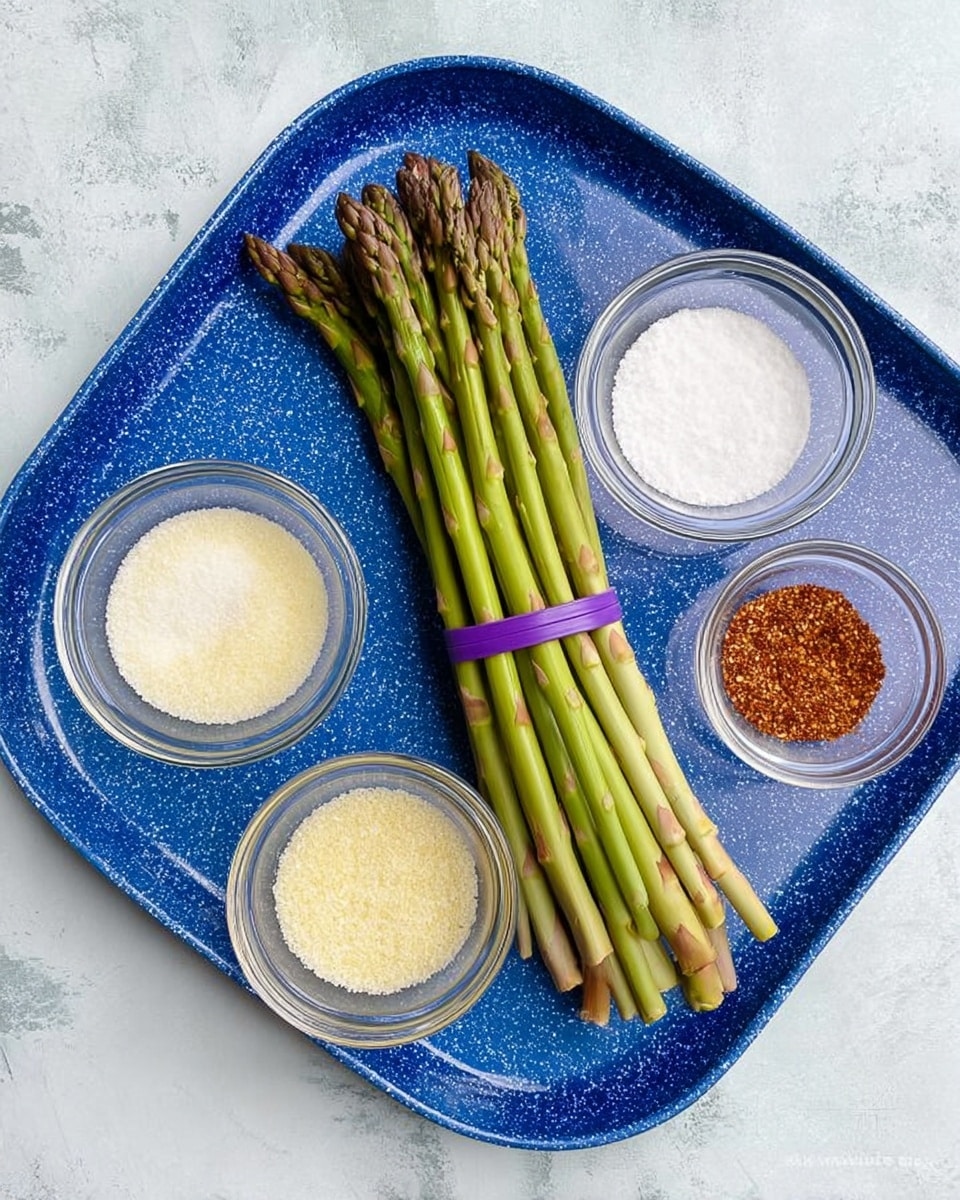 A white marbled surface holds a blue speckled tray with one bundle of fresh green asparagus tied with two purple bands placed in the center. Around the asparagus, there are four small glass bowls arranged loosely: one bowl contains white powder, another holds light yellow granules, a third has off-white liquid, and the last one is filled with reddish-brown seasoning. photo taken with an iphone --ar 4:5 --v 7