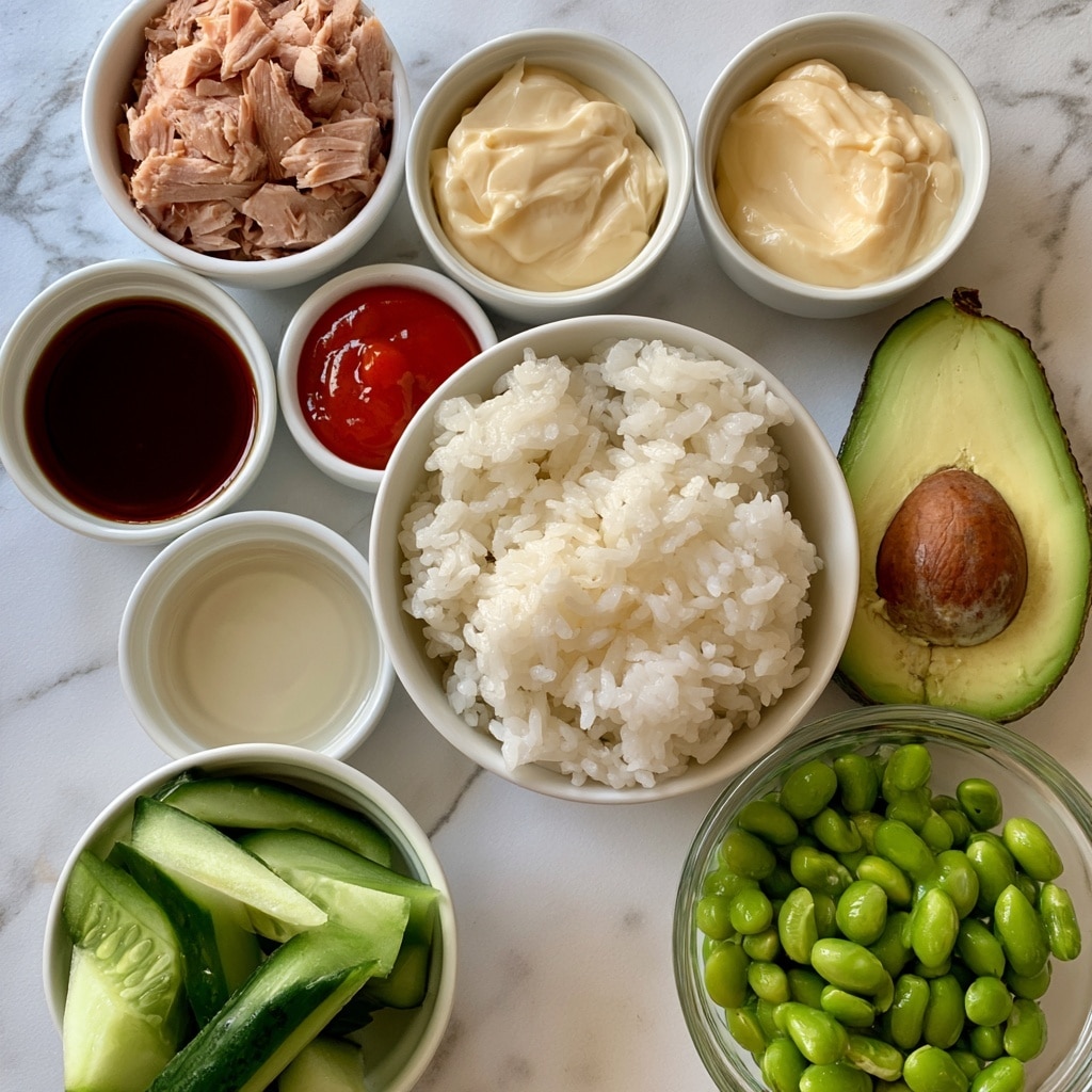 The image shows several small white bowls and one glass bowl arranged on a white marbled surface, each filled with a different ingredient. At the top left is a white bowl filled with flakes of light pink canned tuna. To its right is a white bowl containing creamy, pale yellow kewpie mayonnaise. Below these is a white bowl with dark brown soy sauce, next to a small white bowl with bright red sriracha sauce. Near the center is a larger white bowl filled with fluffy white cooked sushi rice. To the right of the rice is a half avocado with a green outer skin, light green flesh, and a brown seed in the middle. Below the tuna is a white bowl with clear rice wine vinegar. At the bottom left, another white bowl holds fresh, sliced cucumber pieces, green with darker skin edges. Next to it is a clear glass bowl filled with bright green edamame beans. photo taken with an iphone --ar 4:5 --v 7