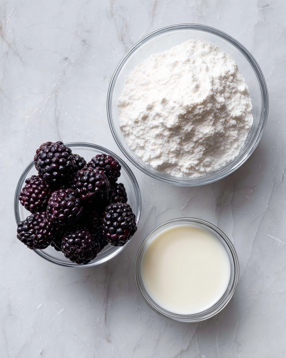 The image shows three small bowls placed on a white marbled surface. The largest bowl at the top right is filled with a fine white powder that looks light and fluffy. To the left of this, a smaller clear bowl holds dark purple blackberries with a textured, bumpy surface. Below and slightly to the right is another small clear bowl containing a smooth, pale liquid, possibly milk or cream. The bowls are arranged close together but not touching. photo taken with an iphone --ar 4:5 --v 7