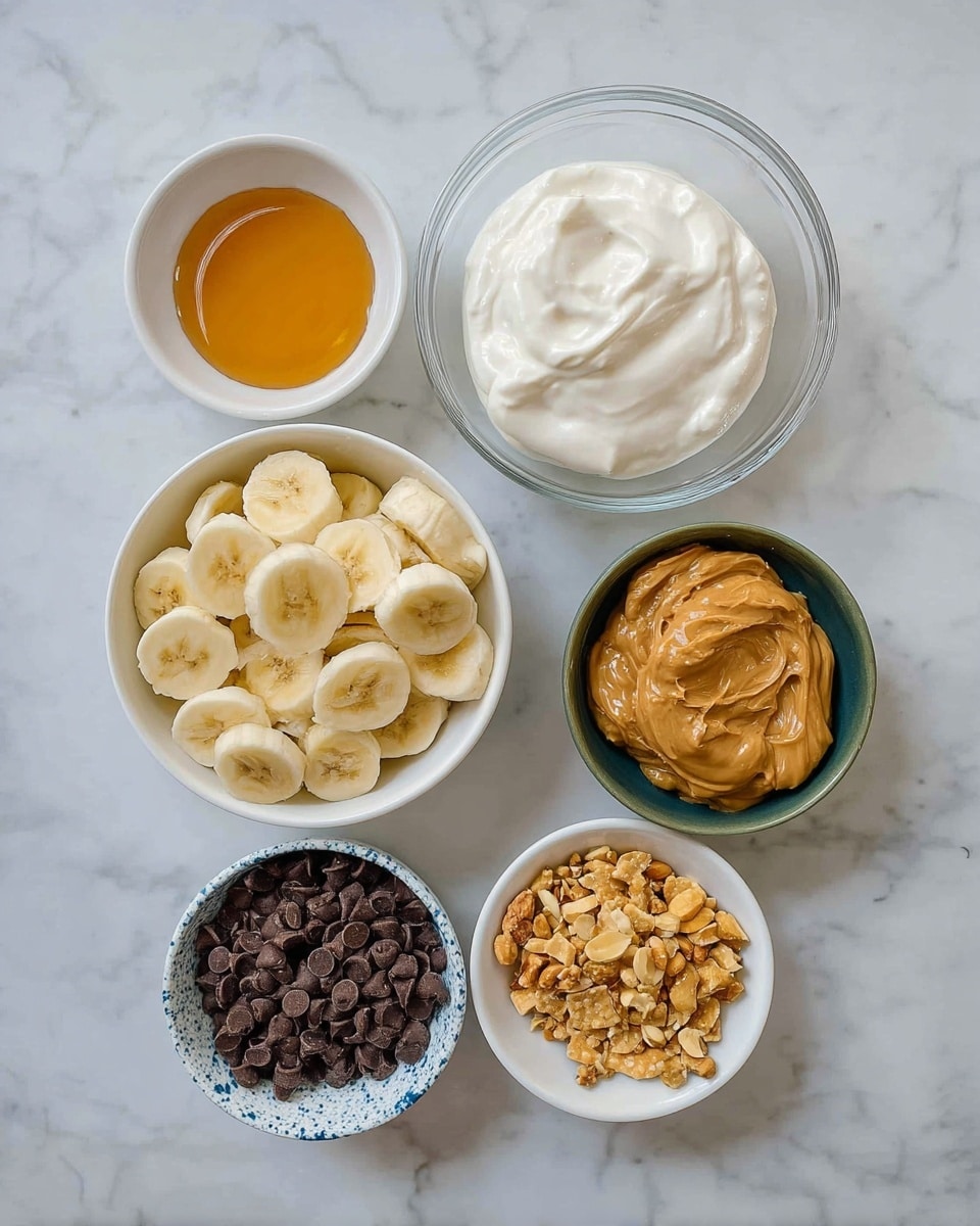 The image shows six bowls with different food items on a white marbled surface. Starting from the top left, there is a small white bowl filled with a golden liquid, likely honey. To the right is a larger clear glass bowl holding thick white cream with a smooth texture. Below the honey bowl is a white bowl with many slices of light yellow banana. Next to the cream bowl is a dark green bowl filled with creamy light brown peanut butter. Below the banana bowl is a white and blue speckled bowl full of dark chocolate chips. Finally, at the bottom, there are two small white bowls side by side; the left one contains broken golden brown crackers and the right one holds crushed light yellow nuts. The items are arranged loosely in a circle with the bowls varying in size. Photo taken with an iphone --ar 4:5 --v 7